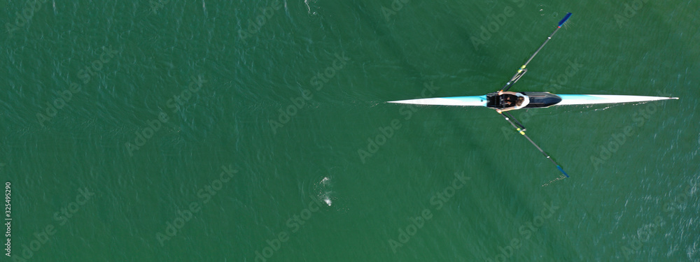Aerial drone ultra wide photo of young athletes rowing in canoe ...
