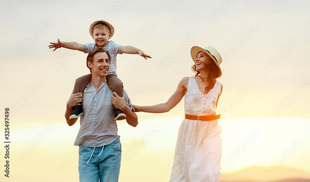 Happy family father of mother and child son  on nature at sunset.