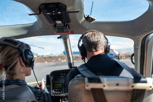 Preparing for helicopter ride with pilot and copilot