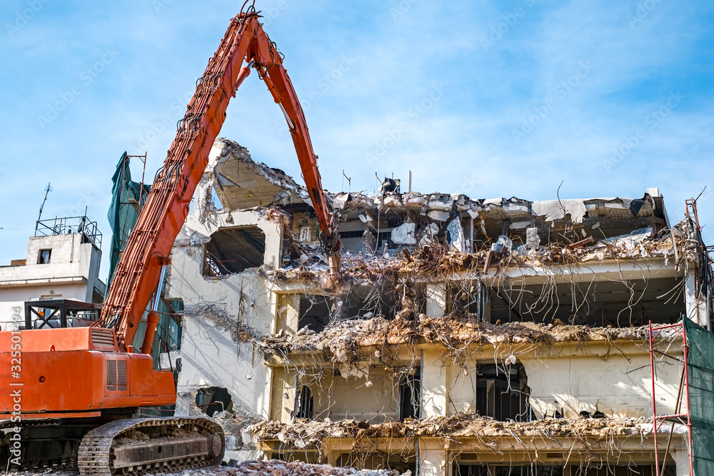 Building demolition with hydraulic excavator