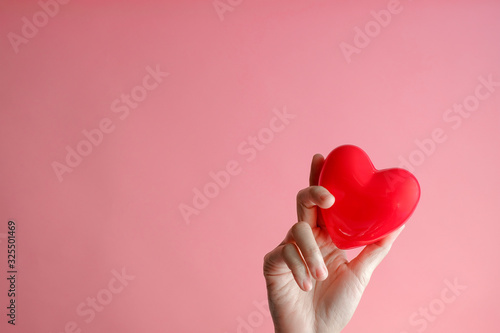 hand carrying heart .love and cardio health concept.valentine and wedding theme.