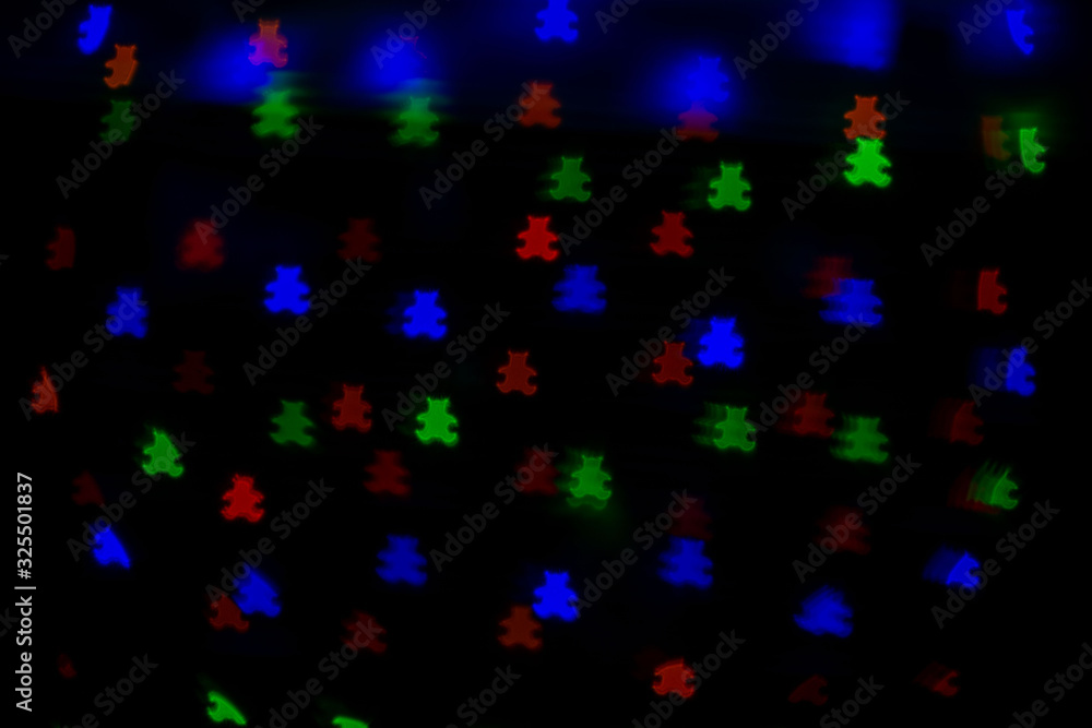 Festive bokeh in the form of spruce of different colors