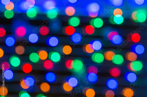Beautiful bokeh in the form of small multicolored circles against a dark background