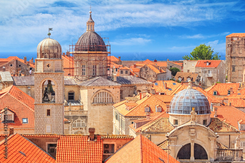 Summer mediterranean cityscape - view of the roofs of the Old Town of Dubrovnik with the Church of St. Blaise and the Assumption Cathedral, on the Adriatic coast of Croatia