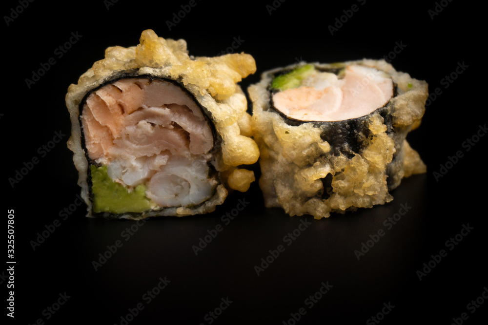 Close up composition of tuna maki sushi rolls japanese food style on a black background Close up composition of tuna maki sushi rolls japanese food style on a black background