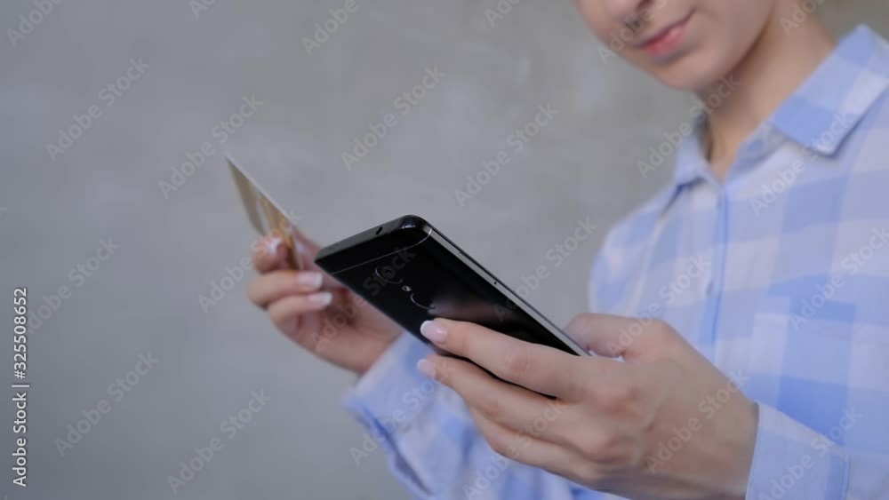 Online shopping, sale, consumerism, electronic payment, technology concept. Close up - woman using black smartphone mobile device, holding credit card, buying goods or ordering online - slow motion Online shopping, sale, consumerism, electronic payment, technology concept. Close up - woman using black smartphone mobile device, holding credit card, buying goods or ordering online - slow motion