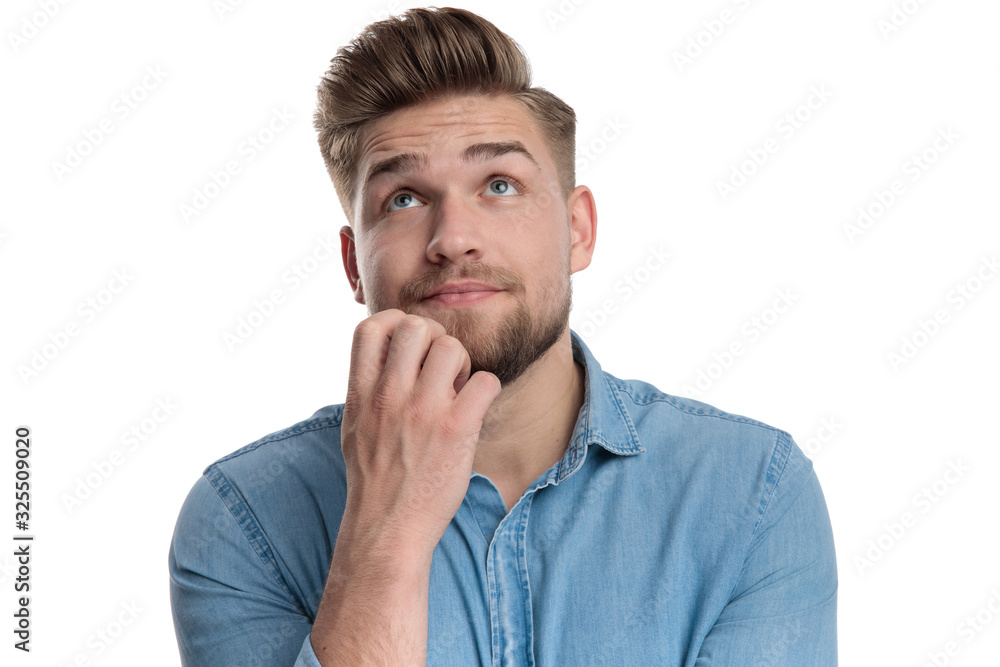 Thoughtful casual man looking upwards Thoughtful casual man looking upwards