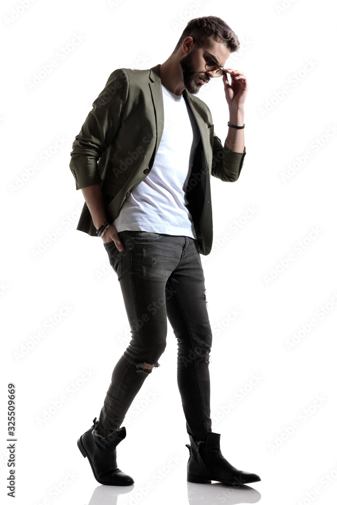 Wondering fashion model adjusting his sunglasses Wondering fashion model adjusting his sunglasses