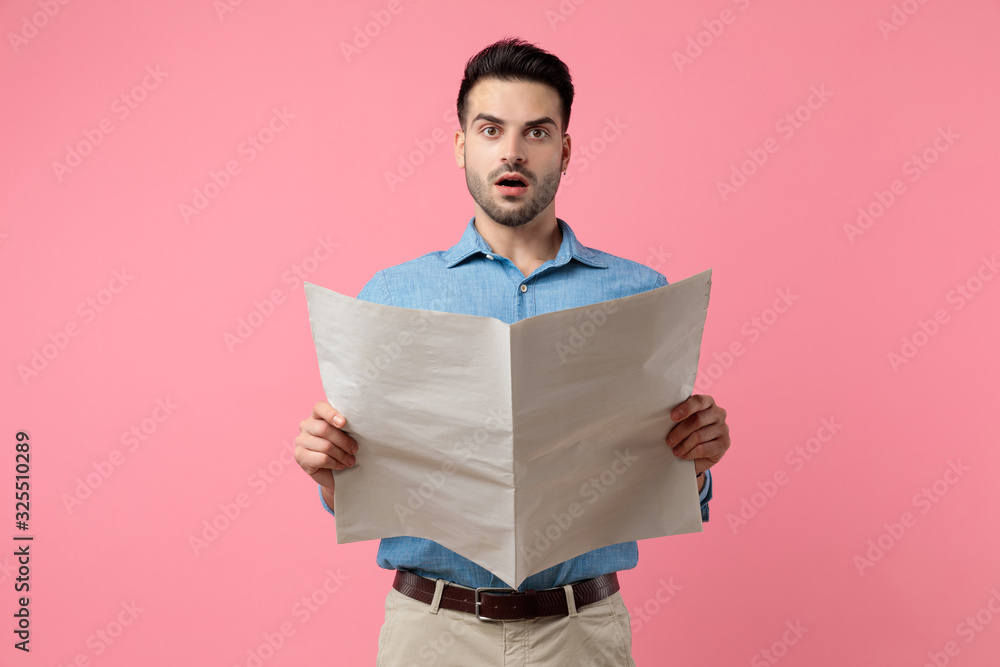 young casual guy reading newspaper young casual guy reading newspaper