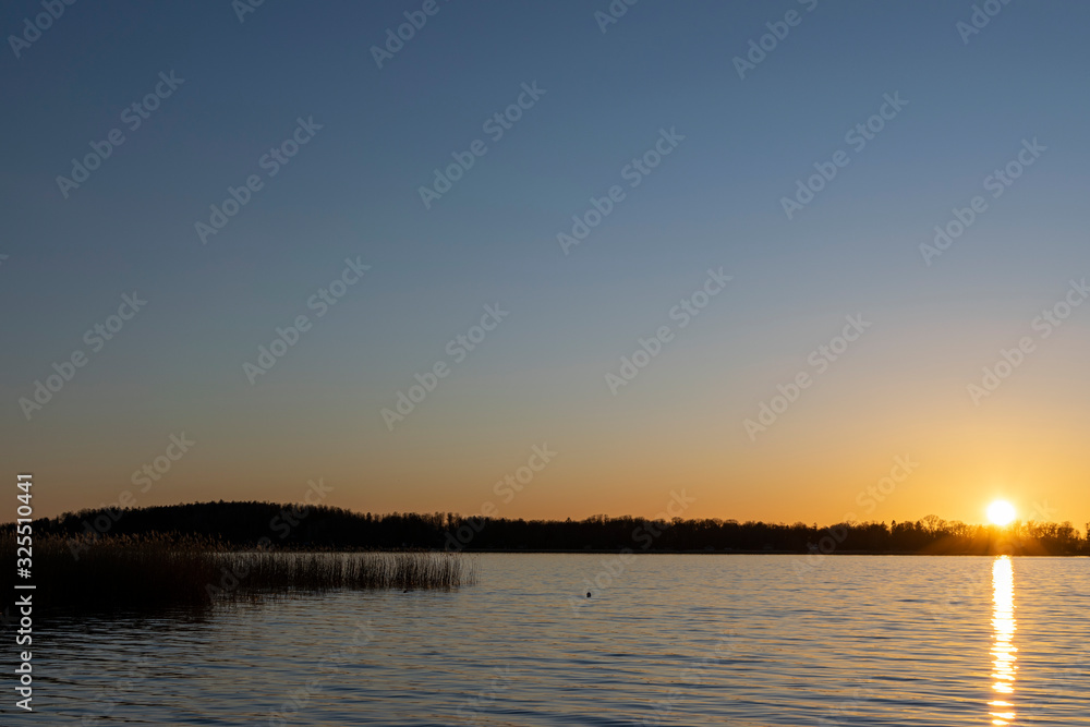 Björnö landscape sunset silhouette with sun reflection