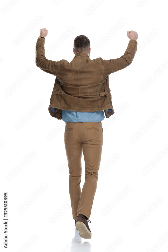 Rear view of casual man celebrating Rear view of casual man celebrating
