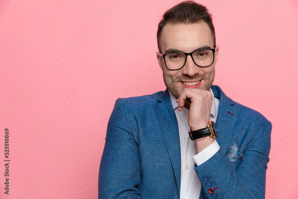 Positive smart casual man smiling with hand on his chin Positive smart casual man smiling with hand on his chin