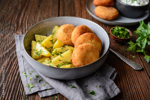 Fried cauliflower and cheese croquettes with boiled potatoes and sour cream dip