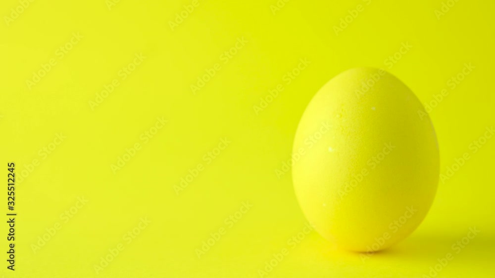 Colorful easter egg on a yellow background. Easter concept background. Colorful easter egg on a yellow background. Easter concept background.