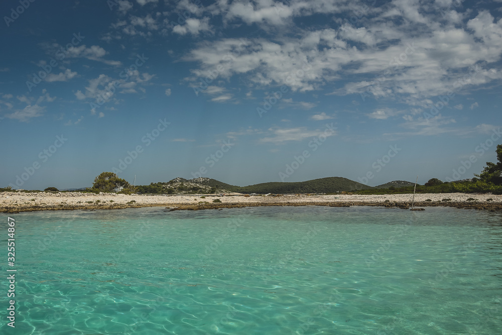 Tourquise coastal panorama of a croatian island, looking from the water towards the shore. Summer feeling and rocky beach. Tourquise coastal panorama of a croatian island, looking from the water towards the shore. Summer feeling and rocky beach.