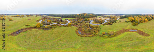 Forest in autumn colors. Colored trees and a meandering blue river. Red, yellow, orange, green deciduous trees in fall. Peetri river, Estonia, Europe photo