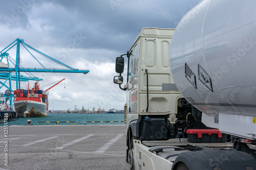 Tanker truck with dangerous goods at the port to supply a ship