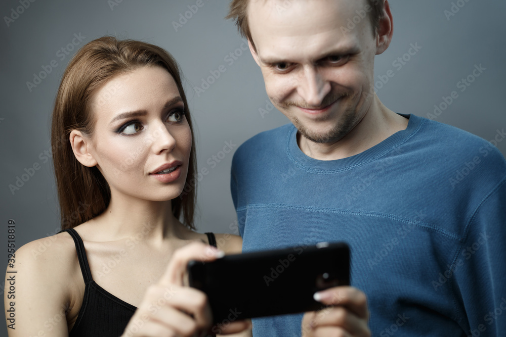 girl shows something to guy on smartphone girl shows something to guy on smartphone