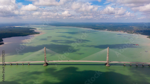 The Johor Bridge at the south of Malaysia from the sky. Cars passing by on the Bridge.  Pass the ocean bay near the city of Singapore. The Highway ends at Desaru Coast, holiday resort for Singaporeans