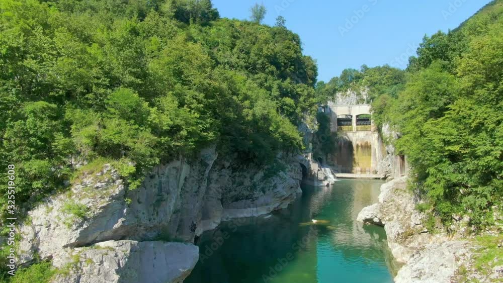 Drone flying low, over a narrow fresh water stream amidst green hills with hidden caves and waterfalls. Tourist destination. Drone flying low, over a narrow fresh water stream amidst green hills with hidden caves and waterfalls. Tourist destination.
