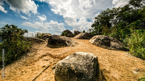 On the top of Broga Hill, Selangor, Malaysia. On the peak of the mountain, during a hiking tour. Rocks are in the way. Yellow soil under blue sky on a hot day at south east Asia. Truly Asia 