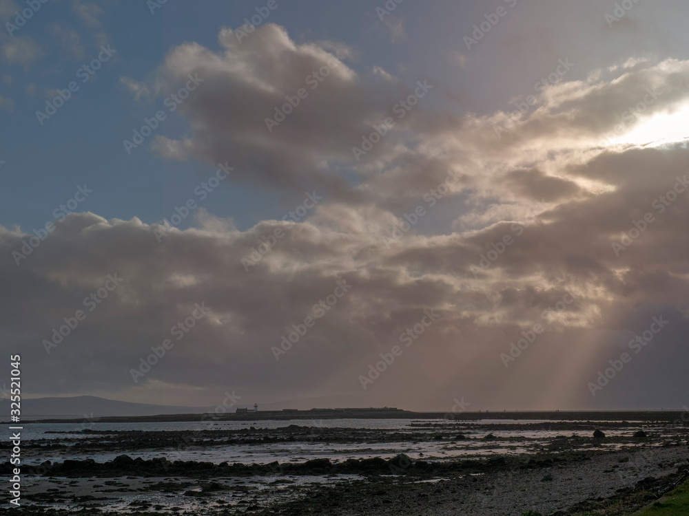 Dramatic sky with sun rays over Mutton island, Galway city, Ireland, Dramatic sky with sun rays over Mutton island, Galway city, Ireland,