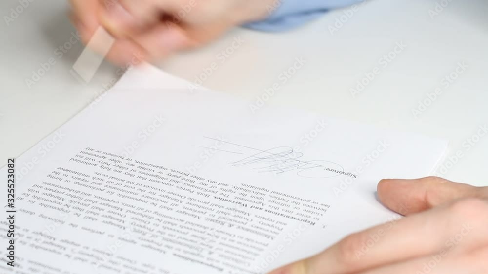 Closeup shot of a business man signing a contract, legal agreement or paper. Man is approve documents by signing papers. Closeup shot of a business man signing a contract, legal agreement or paper. Man is approve documents by signing papers.