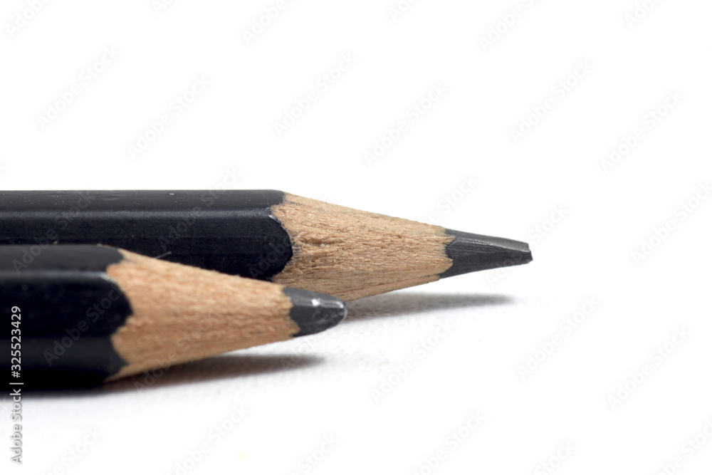 Graphite wooden pencil on an isolated white background Graphite wooden pencil on an isolated white background