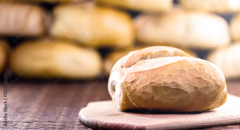 traditional Brazilian bread, called French bread, with an unfocused bakery background. National day of Brazilian French bread. traditional Brazilian bread, called French bread, with an unfocused bakery background. National day of Brazilian French bread.