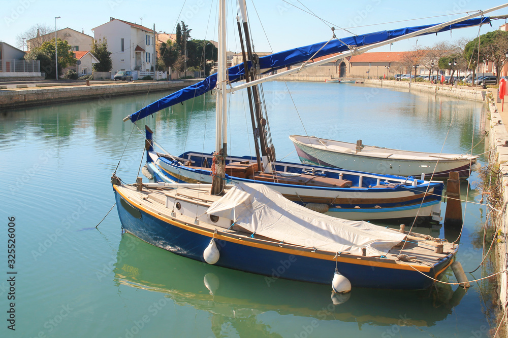 Traditional boats in the river port of Frontignan, a seaside resort in the Mediterranean sea, Herault, Occitanie, France Traditional boats in the river port of Frontignan, a seaside resort in the Mediterranean sea, Herault, Occitanie, France