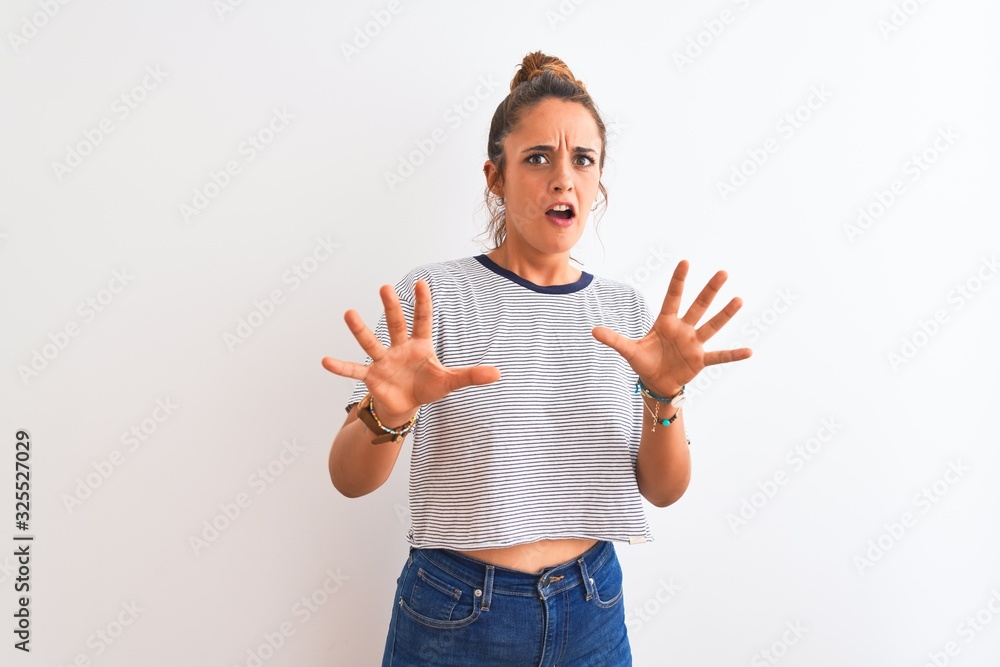 Young redhead modern woman wearing a bun over isolated background afraid and terrified with fear expression stop gesture with hands, shouting in shock. Panic concept. Young redhead modern woman wearing a bun over isolated background afraid and terrified with fear expression stop gesture with hands, shouting in shock. Panic concept.