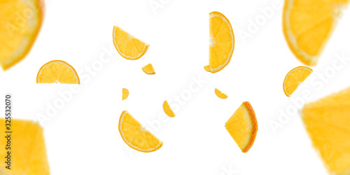 Sliced fruit falling background. Orange citrus tangerine flight in air with clipping path.