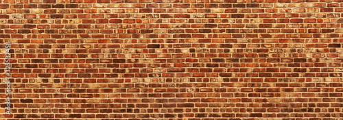 Panoramic background of wide old red and brown brick wall texture. Home or office design backdrop. Vintage brickwall. Red brick wall texture grunge background. Brick wall of red color, wide panorama