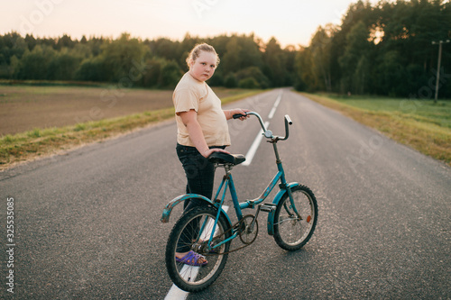Picture of a chubby girl rides a bike in village