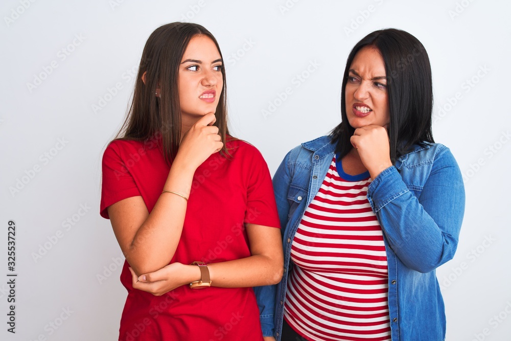 Young beautiful women wearing casual clothes standing over isolated white background Thinking worried about a question, concerned and nervous with hand on chin Young beautiful women wearing casual clothes standing over isolated white background Thinking worried about a question, concerned and nervous with hand on chin