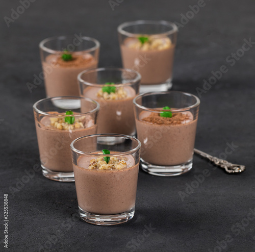 Italian dessert Panna cotta chocolate nut in a glass on a dark background