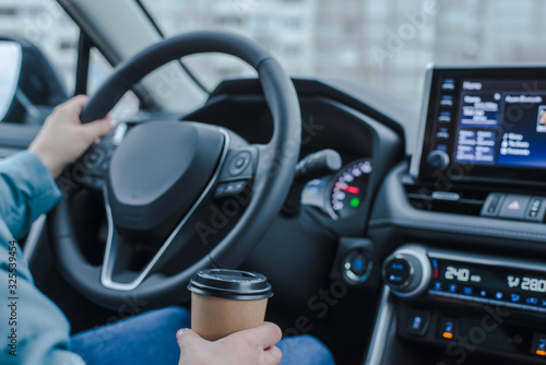 Close up young girl car driver drink coffee, hand holding a Paper Cup of coffee. Travel with coffee.  Concept of coffee with you. Mockup © FakeMoon