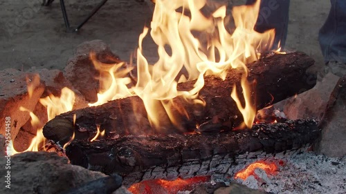A camp fire burns brightly 