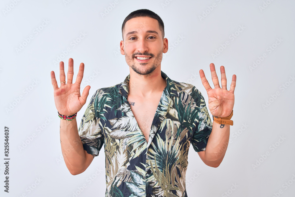 Young handsome man wearing Hawaiian summer shirt over isolated background showing and pointing up with fingers number nine while smiling confident and happy. Young handsome man wearing Hawaiian summer shirt over isolated background showing and pointing up with fingers number nine while smiling confident and happy.