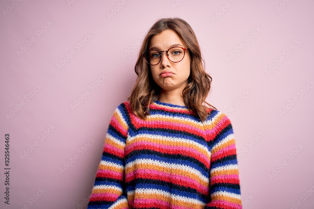 Young beautiful blonde girl wearing glasses and casual sweater over pink isolated background depressed and worry for distress, crying angry and afraid. Sad expression. Young beautiful blonde girl wearing glasses and casual sweater over pink isolated background depressed and worry for distress, crying angry and afraid. Sad expression.