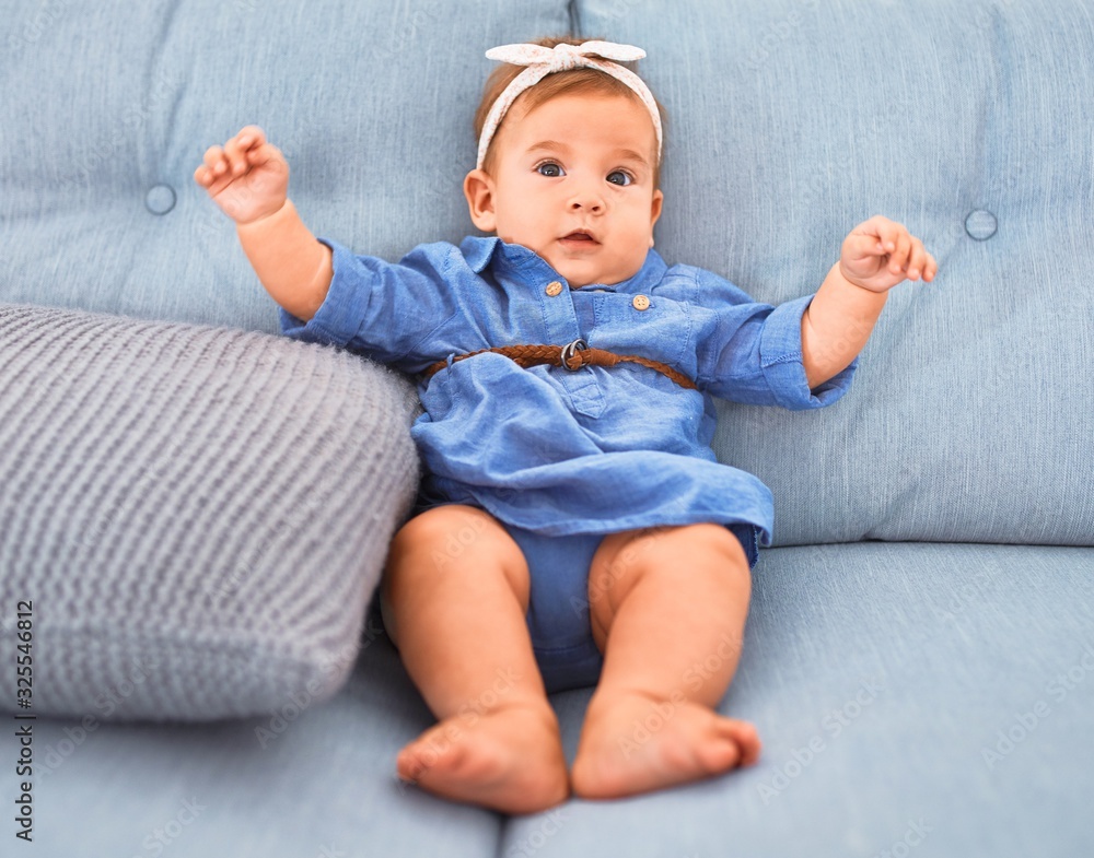 Adorable baby lying down on the sofa at home. Newborn relaxing and resting comfortable Adorable baby lying down on the sofa at home. Newborn relaxing and resting comfortable