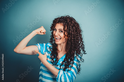 Tela I am strong, I can do it. Strong curly woman showing bicep