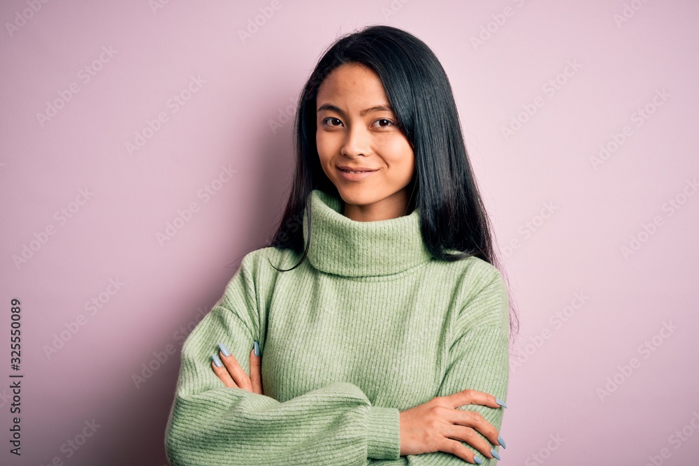 Young beautiful chinese woman wearing turtleneck sweater over isolated pink background happy face smiling with crossed arms looking at the camera. Positive person. Young beautiful chinese woman wearing turtleneck sweater over isolated pink background happy face smiling with crossed arms looking at the camera. Positive person.