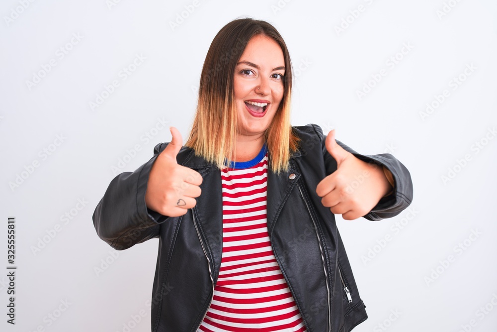Young beautiful woman wearing striped shirt and jacket over isolated white background approving doing positive gesture with hand, thumbs up smiling and happy for success. Winner gesture. Young beautiful woman wearing striped shirt and jacket over isolated white background approving doing positive gesture with hand, thumbs up smiling and happy for success. Winner gesture.
