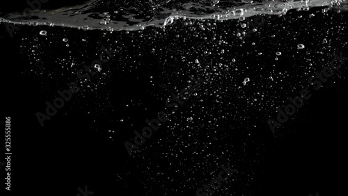 Bubbles underwater splashing and floating up and black color background which represent carbonate drink such as soda or cola and sparkling water from nature that can use for refreshing or freshing con