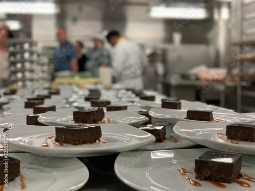 Картината върху платно Pastry chef is cooking many chocolate cakes