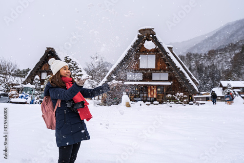 Young woman traveler enjoying with snow at shirakawa-go in winter
