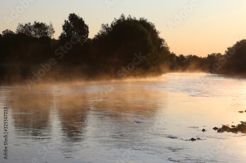 Golden mist rises off the Conestogo River, just outside St. Jacobs, Ontario, Canada.