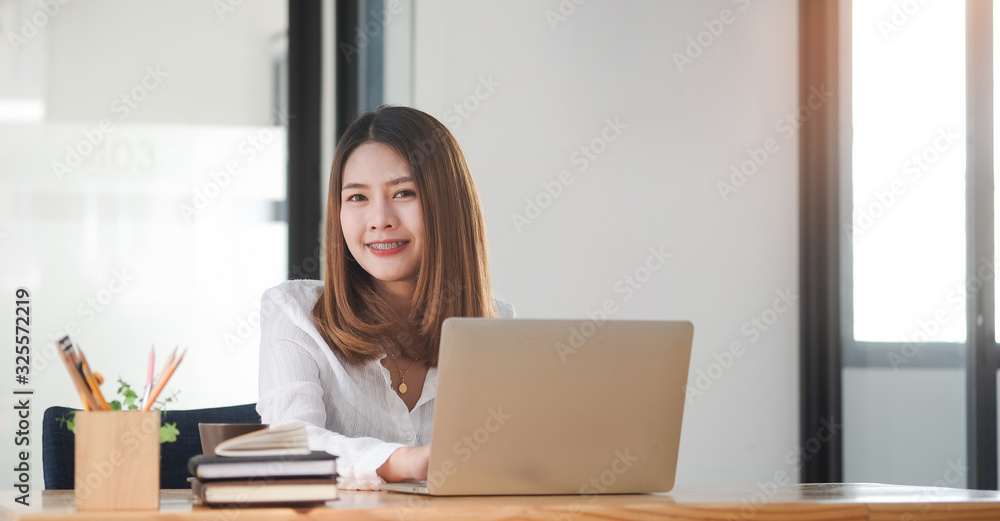 Concept business woman working and people happy businesswoman or creative female office worker with computers writing to notebook with documents and laptop. Concept business woman working and people happy businesswoman or creative female office worker with computers writing to notebook with documents and laptop.