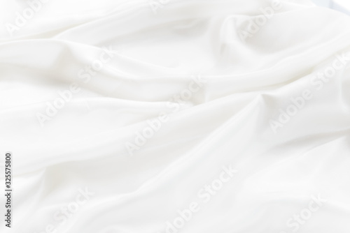 abstract background or texture of rippled white silk fabric lines